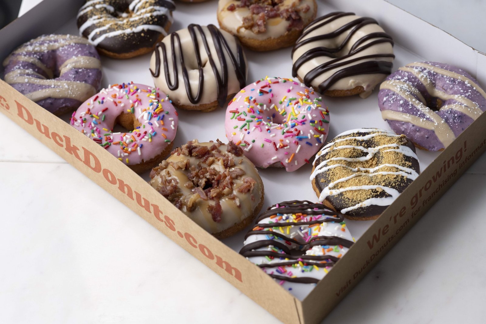 Duck Donuts team preparing fresh donuts